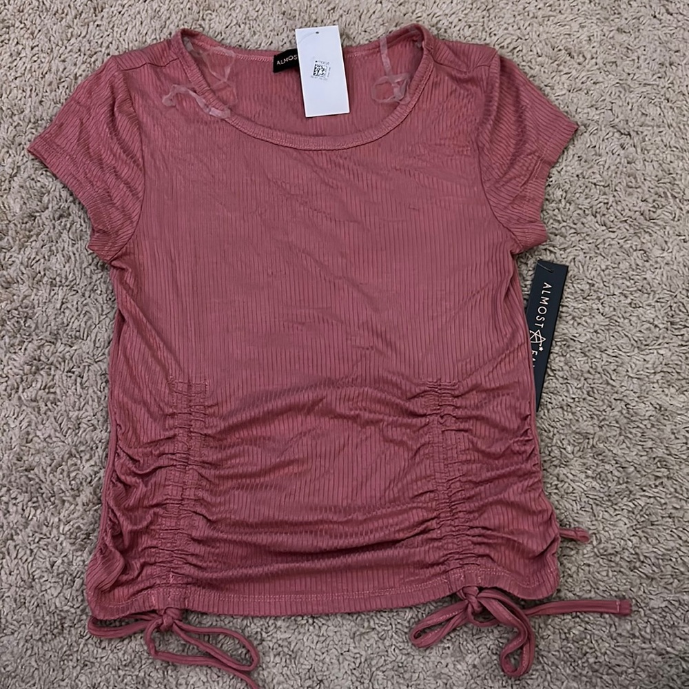 Pink Women’s tight fitting shirt.